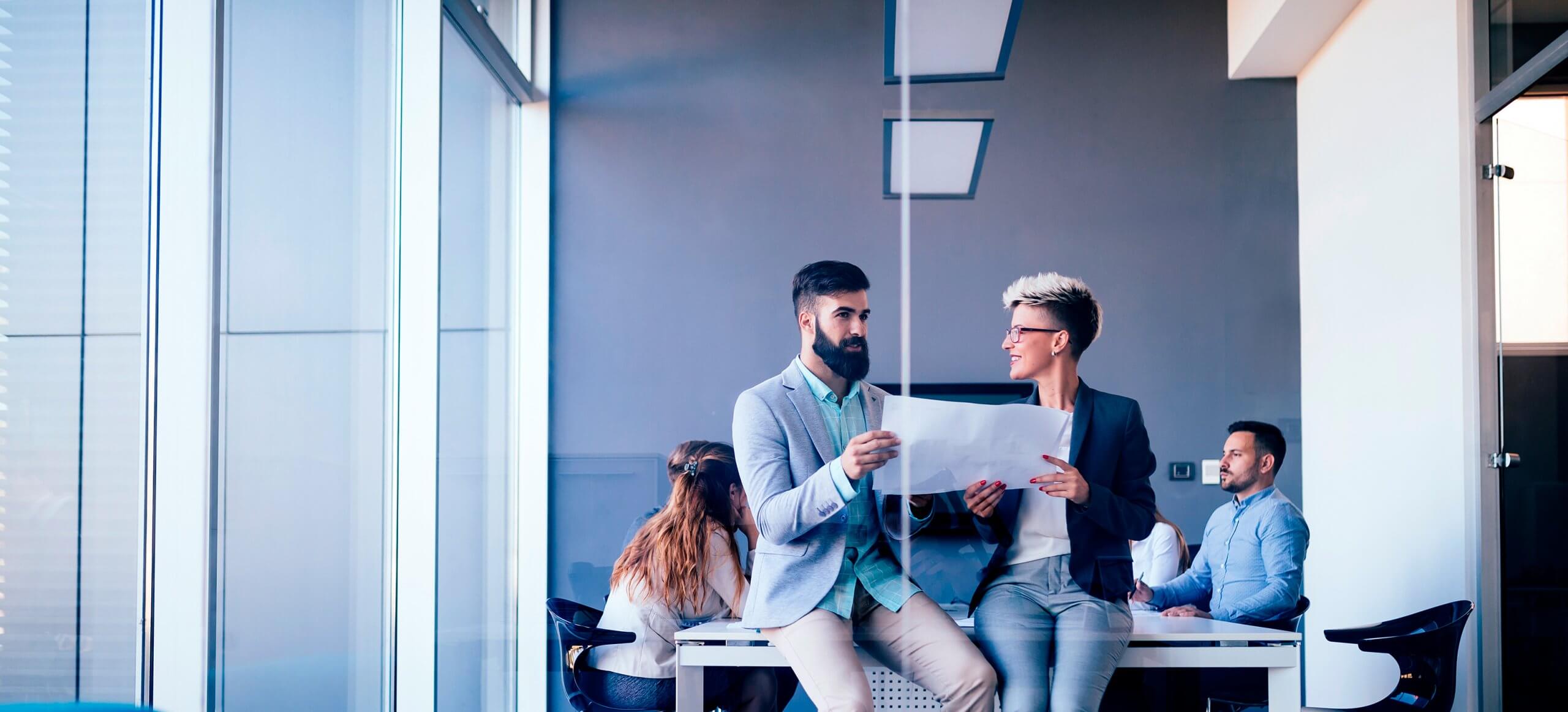 young-designers-talking-on-break-about-business-PGZWAT7-scaled.jpg